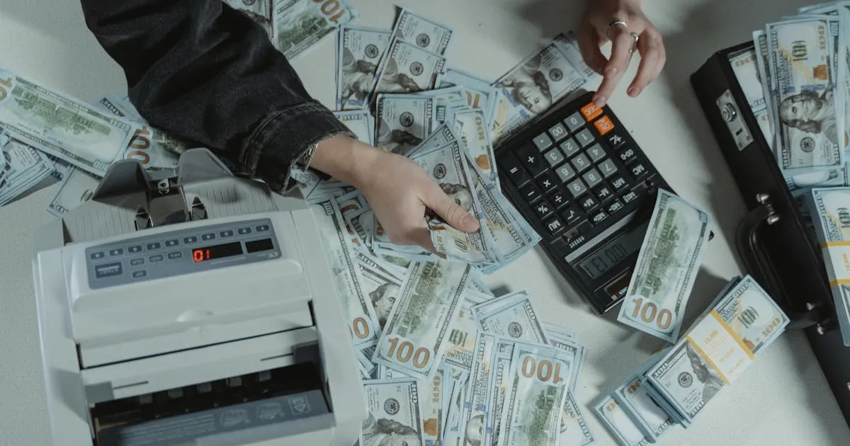 Counting cash with calculator to plan India hiring cost