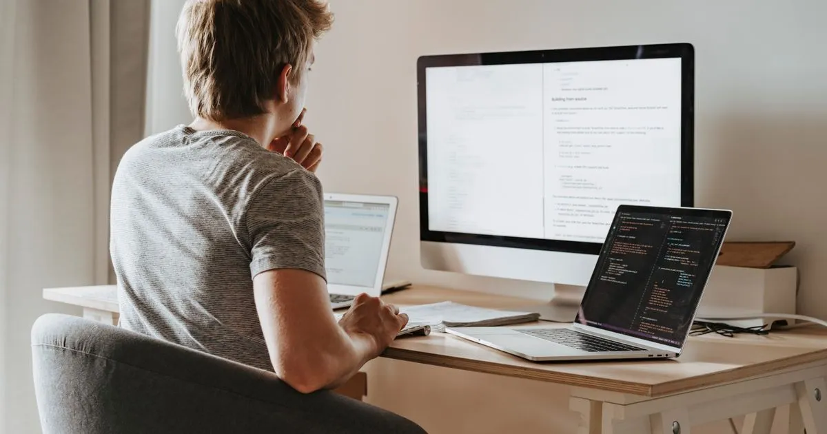 Frontend developer working on UI code on a laptop