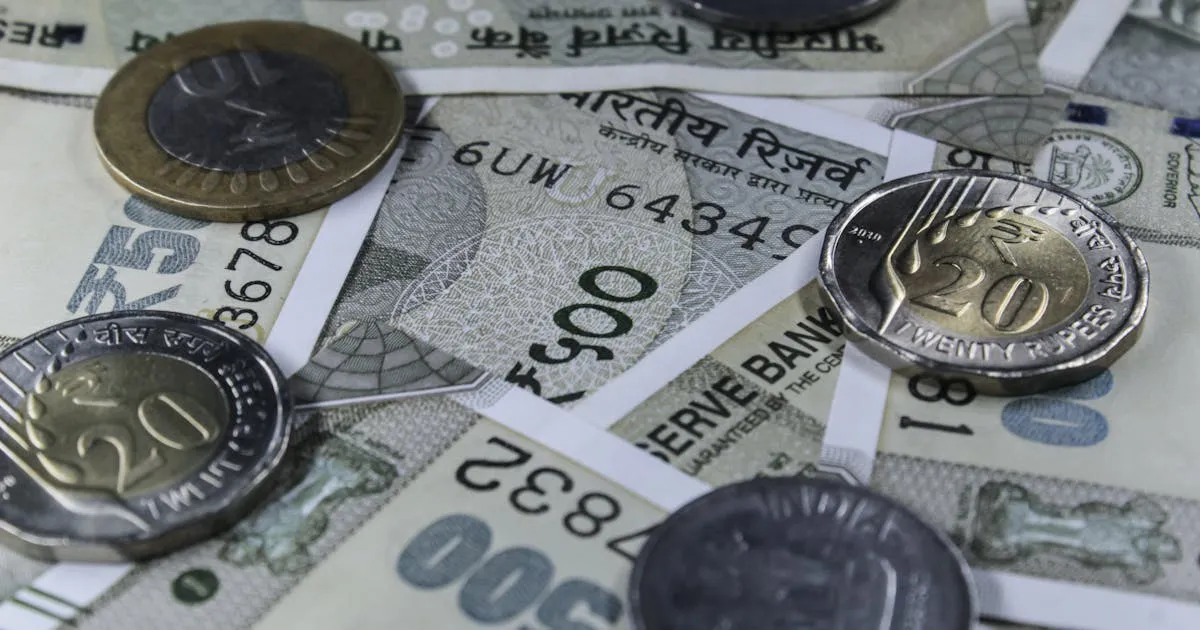 Indian rupee banknotes and coins representing CTC salary components