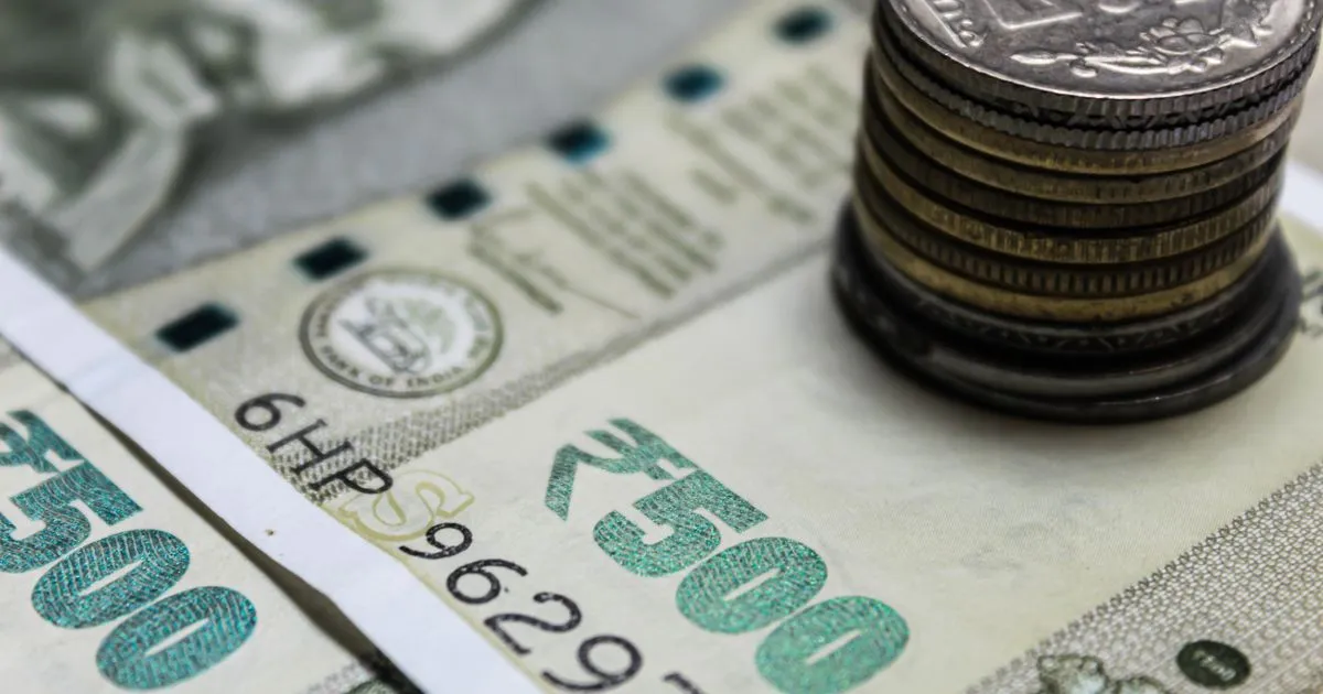 Indian rupees and stacked coins, dearness allowance