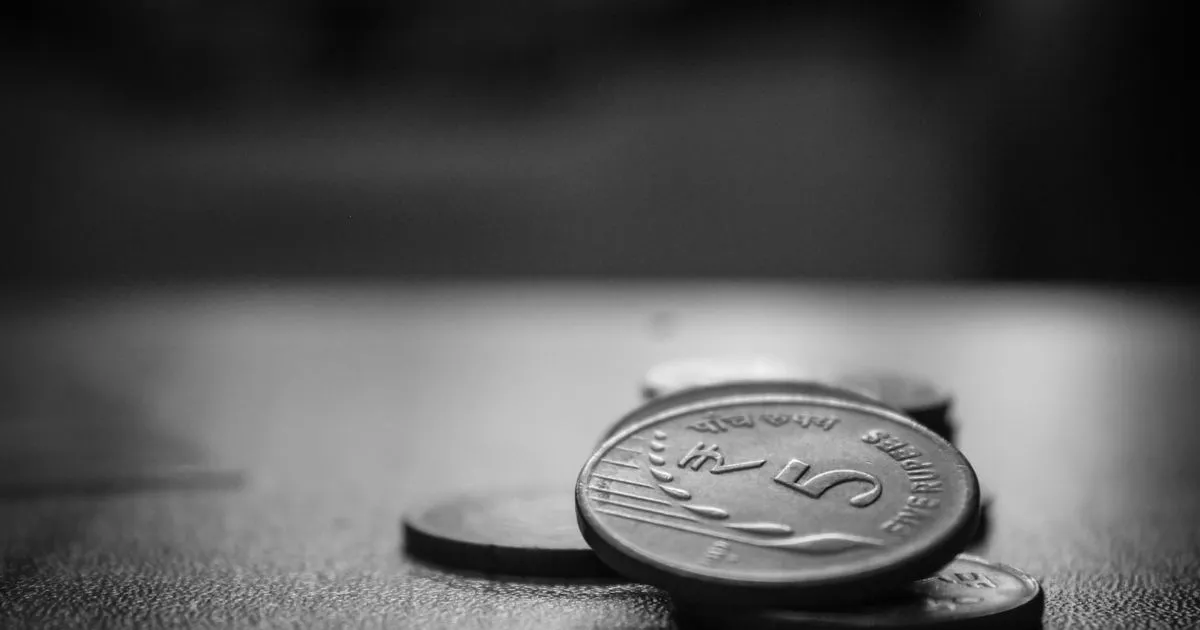 Stacked Indian five rupee coins, minimum wage