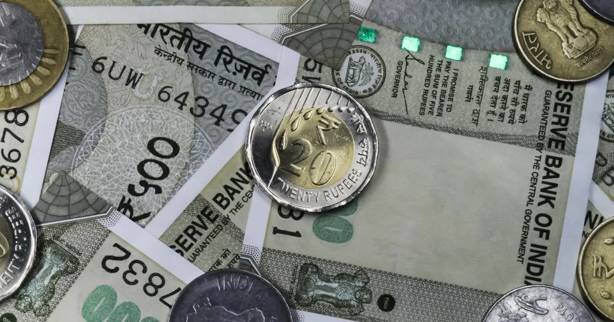 Stacks of Indian rupees and coins, bonus payment