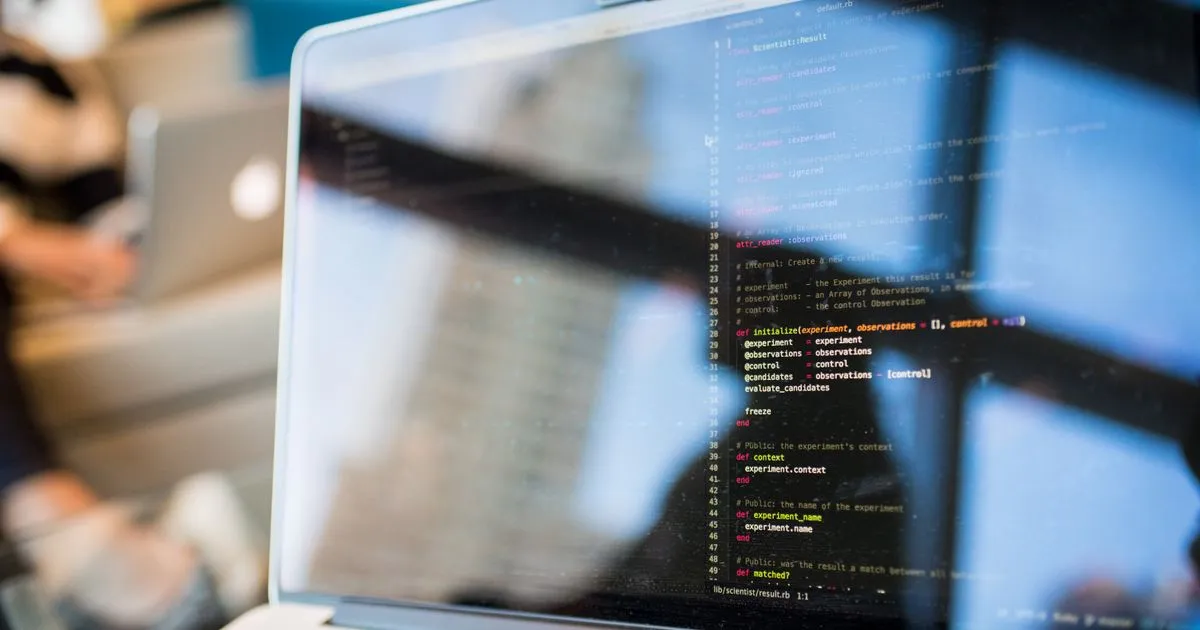 Software developer writing code at a workstation